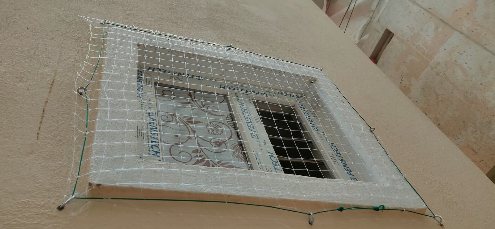 Pigeon prevention net covering a window