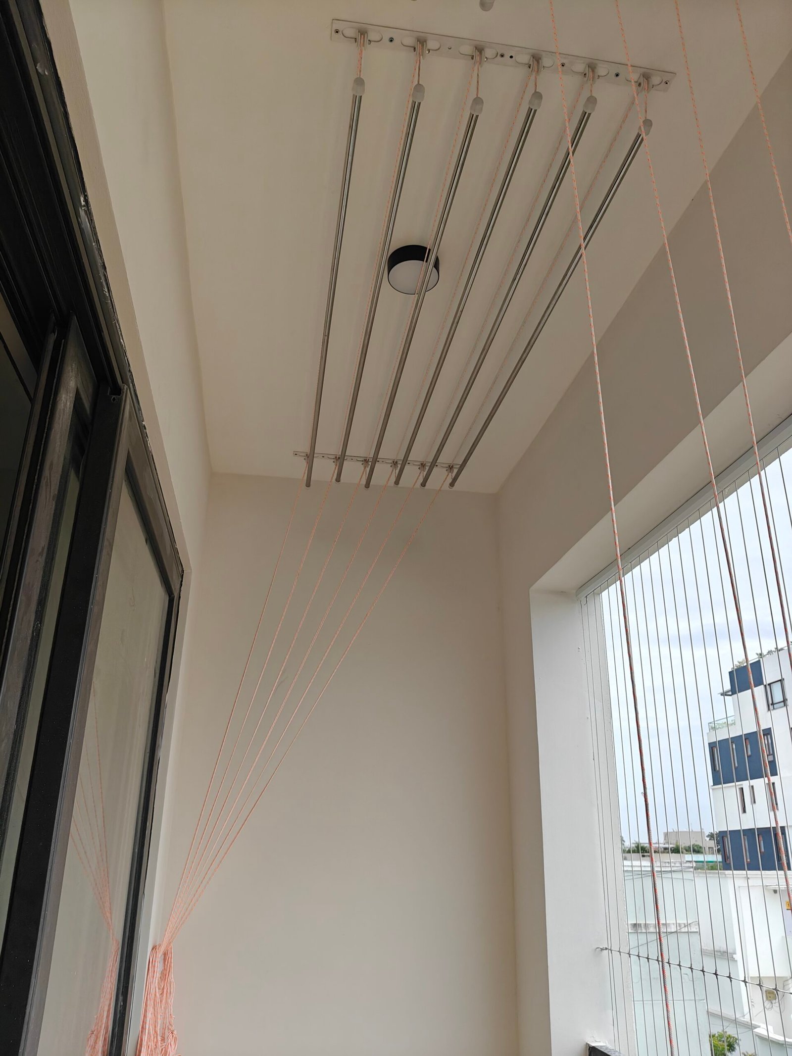 Ceiling pulley cloth hanger fitted in a Chennai utility balcony
