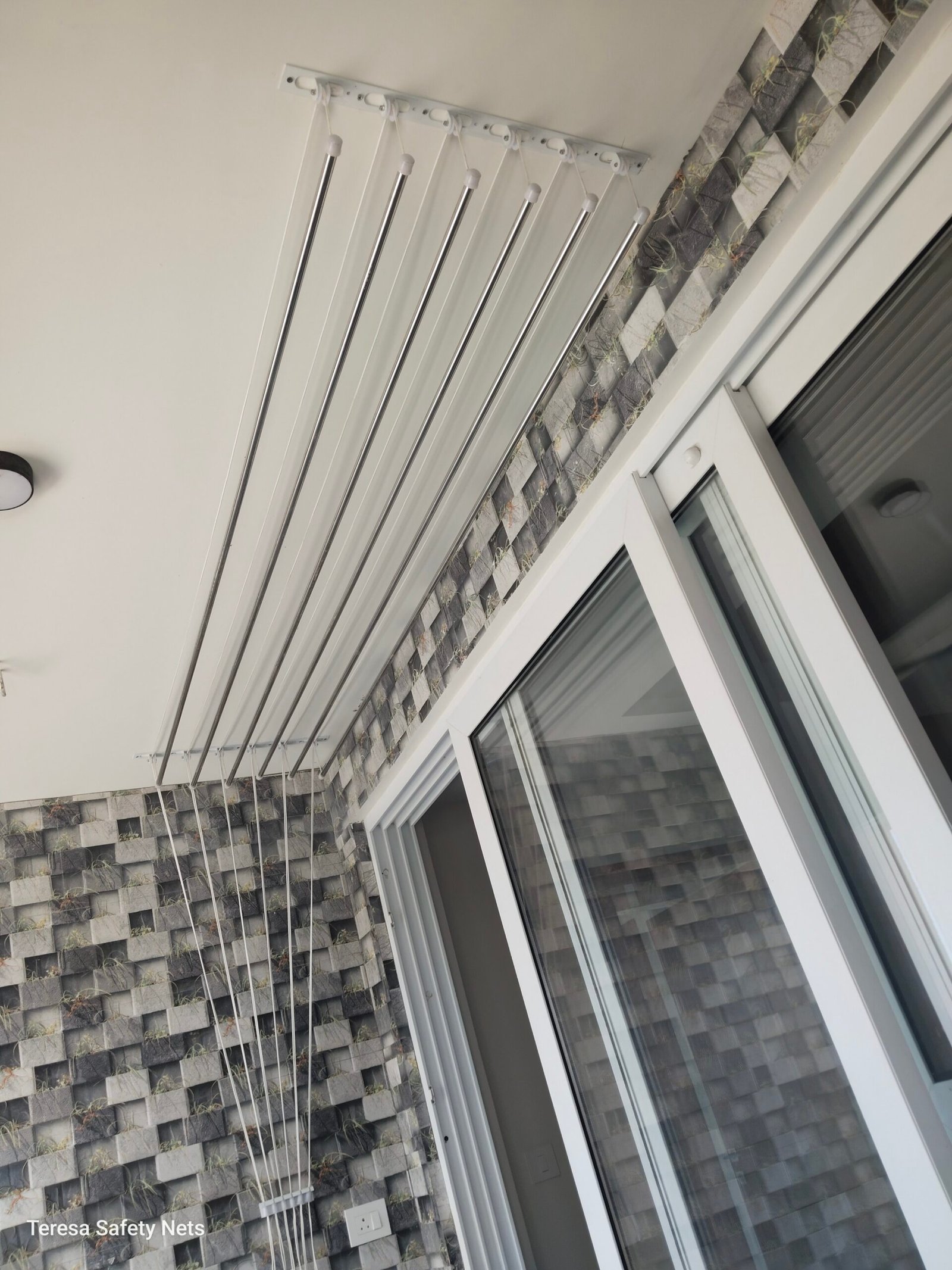 Ceiling pulley cloth hanger in a utility area